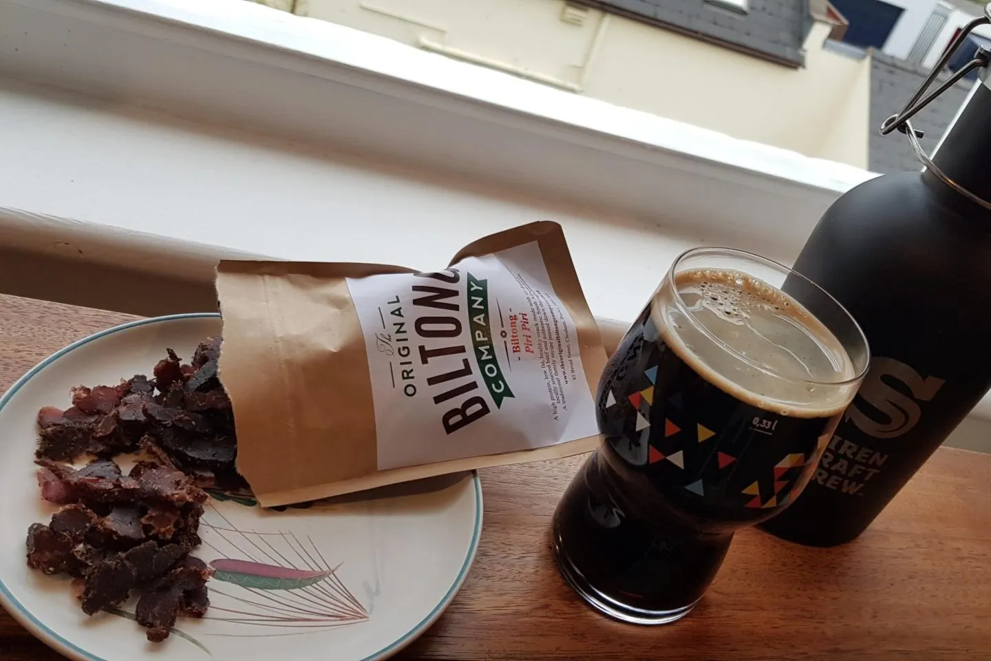 Biltong and a dark beer on the window ledge