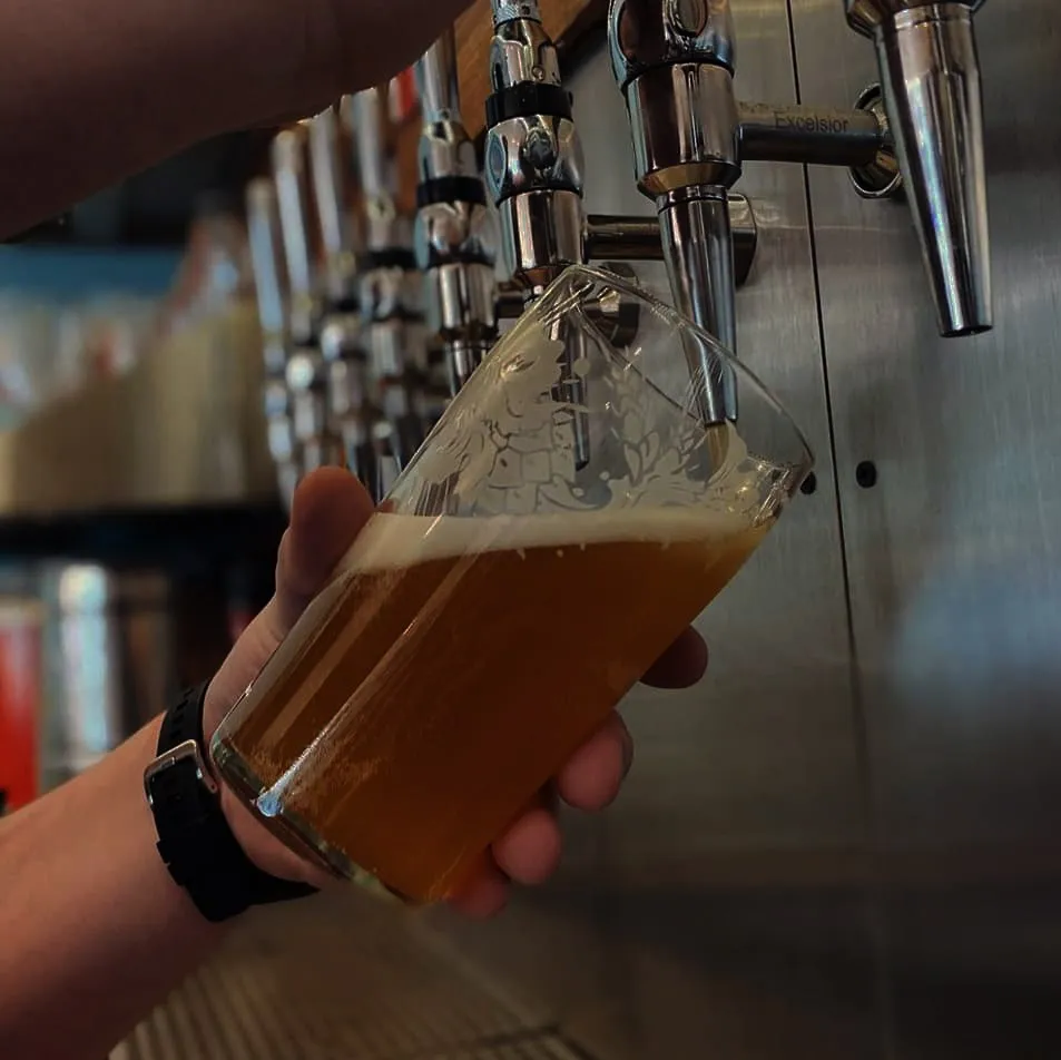 A pint being poured at the taps